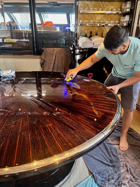 PPF installation on high gloss wood yacht table